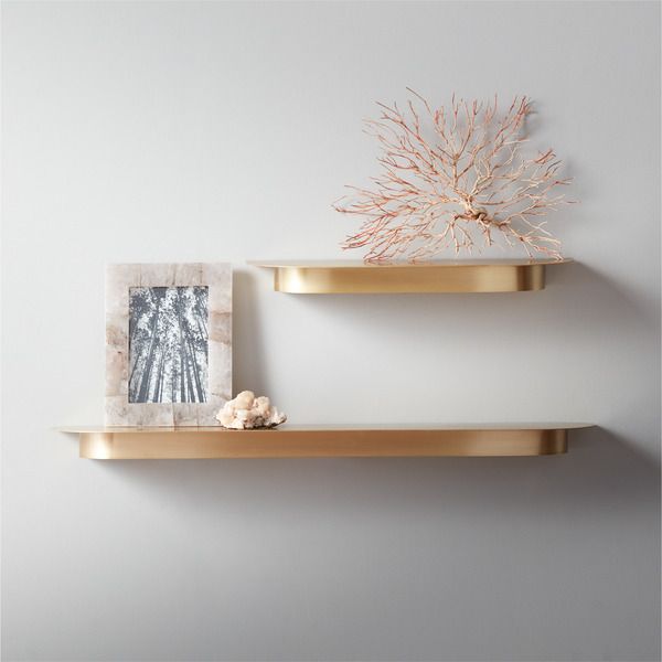 two gold floating shelves styled with decor